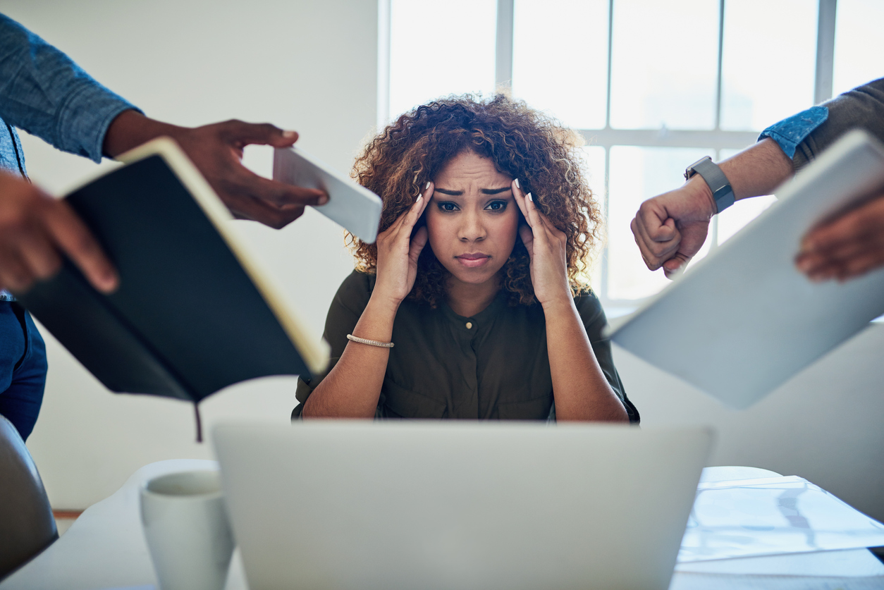 Shot of a stressed out young woman with ADHD working in a demanding career