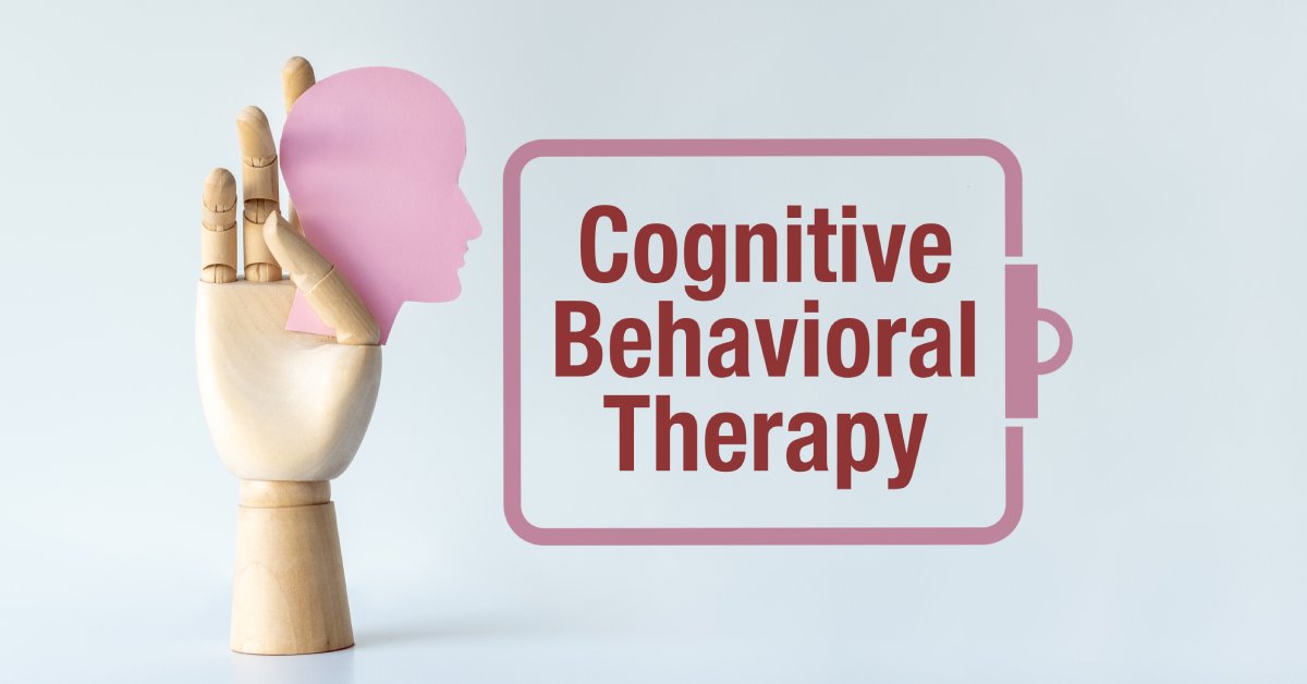 A hand mold holds a pink cutout of a person’s head. A pink clipboard drawing contains the words “Cognitive Behavioral Therapy.”