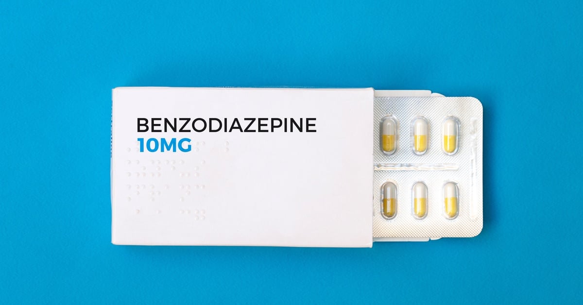A Benzodiazepine 10mg medication box with a blister pack of yellow and white capsules against a blue background.